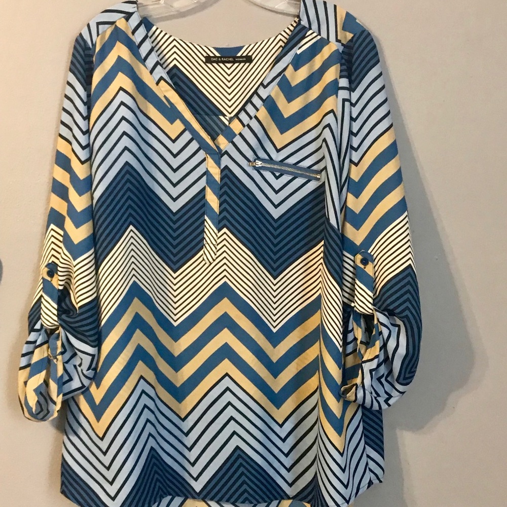 Long sleeve dressy blouse with zipper pocket.